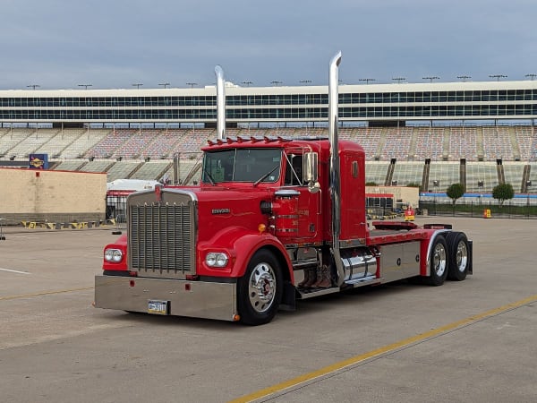 A red Kenworth W900 tractor.