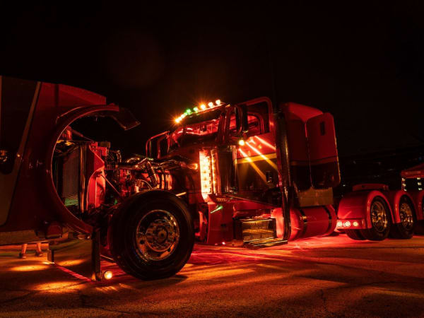Peterbilt truck lit up at night.