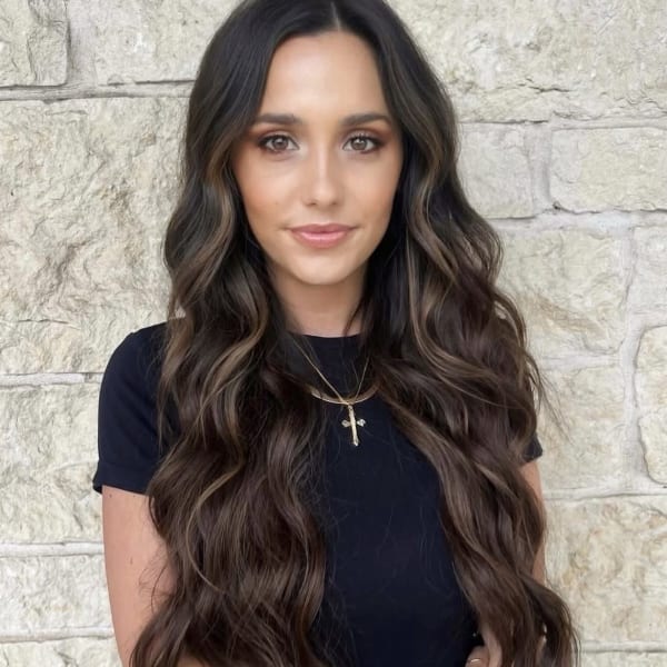 A woman with long brunette hair. 