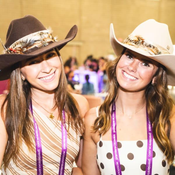 Two women wearing cowboy hats