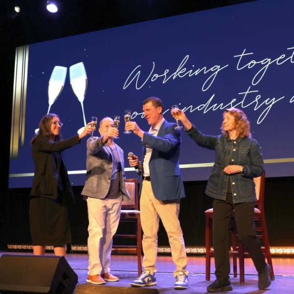 ISBN's Government Affairs Committee toasting on stage