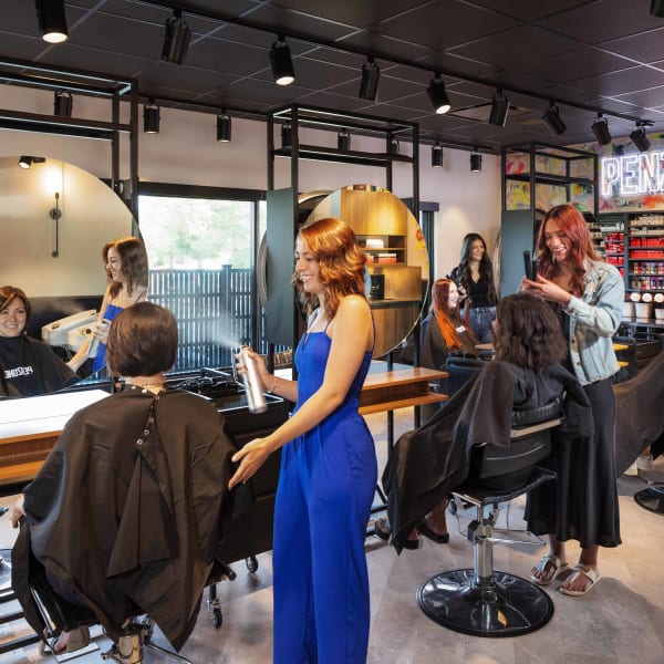 Stylists work with clients inside the training salon within BASE ONE, the PENZONE Salons+Spas' training center in Columbus, Ohio.