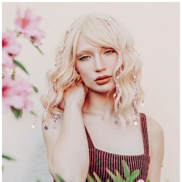A blonde haired woman with tinsel strands.