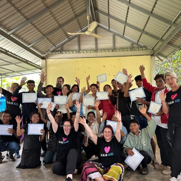A group of people raising their hands.