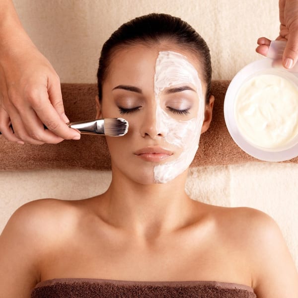 A woman receives a facial treatment.