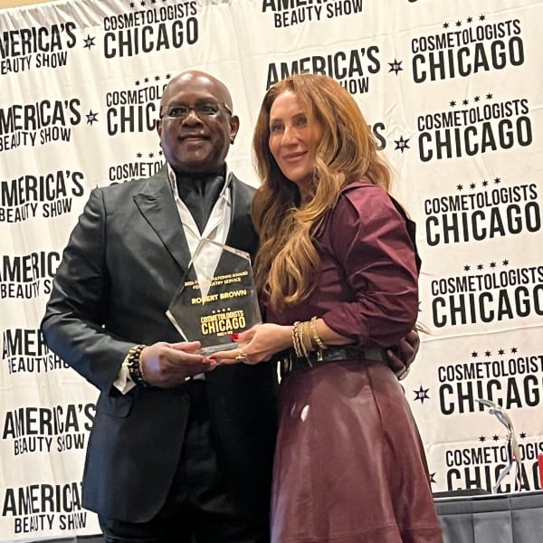 Robert Brown is presented his award by Anna Manukyan, Treasurer, Cosmetologist Chicago Board Member