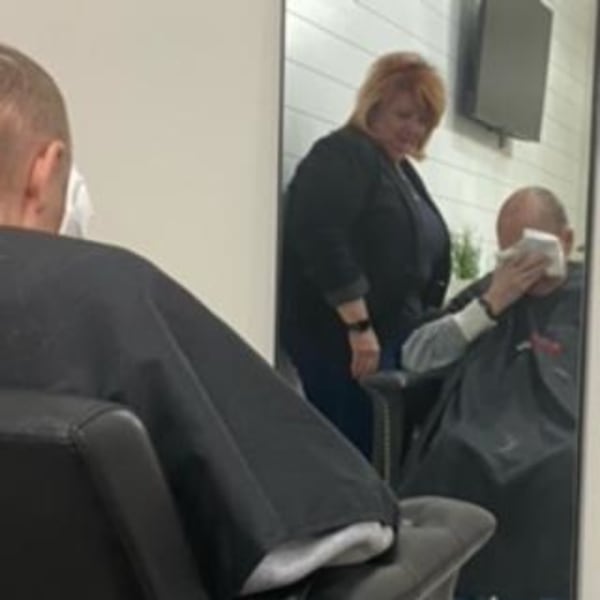 A hairstylist and her client, sitting in a chair