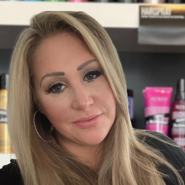Tilting her long blond hair to the side, Kyndell Walker, salon manager at Genesis Salon and Spa