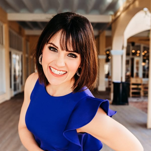A smiling woman in a blue dress