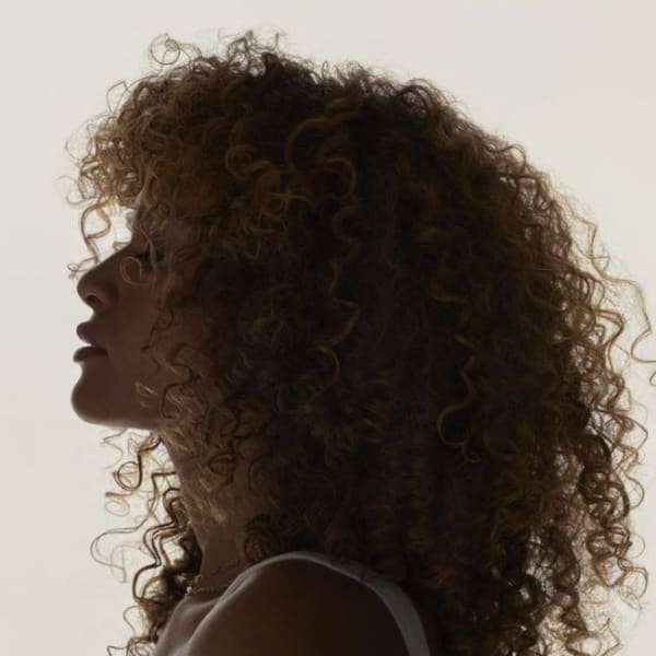 A woman with curly hair in profile.