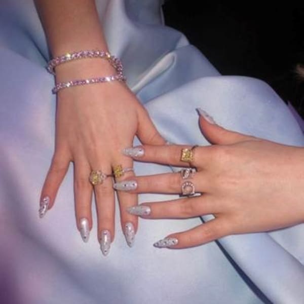 Hands with long fingernails and blue nail polish