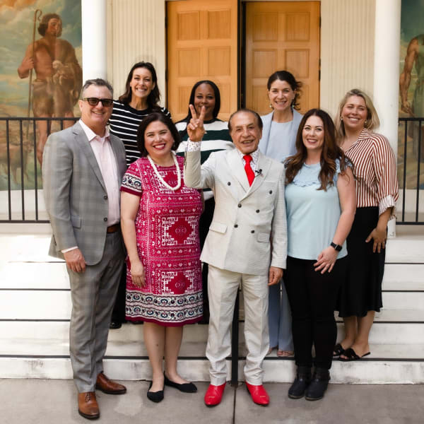 a group of people standing together on a set of stairs