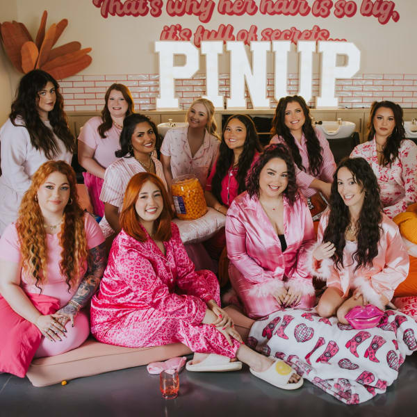 Pretty in pink, the team from Pinup Studio enjoy a pajama party in the salon.