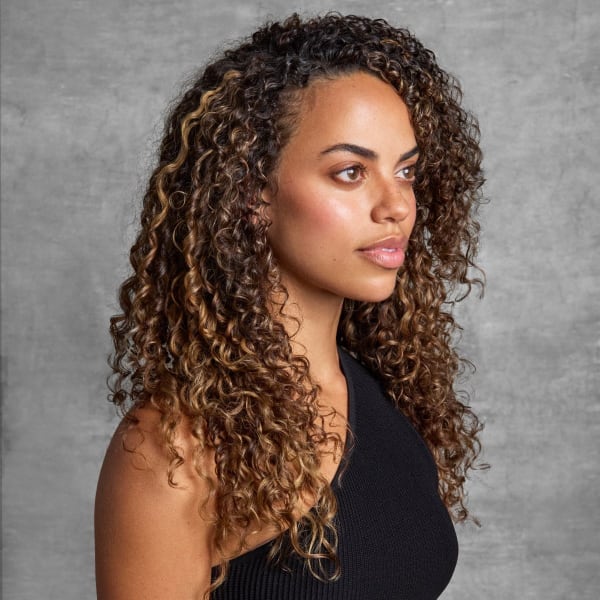 woman with brown, curly hair, in profile