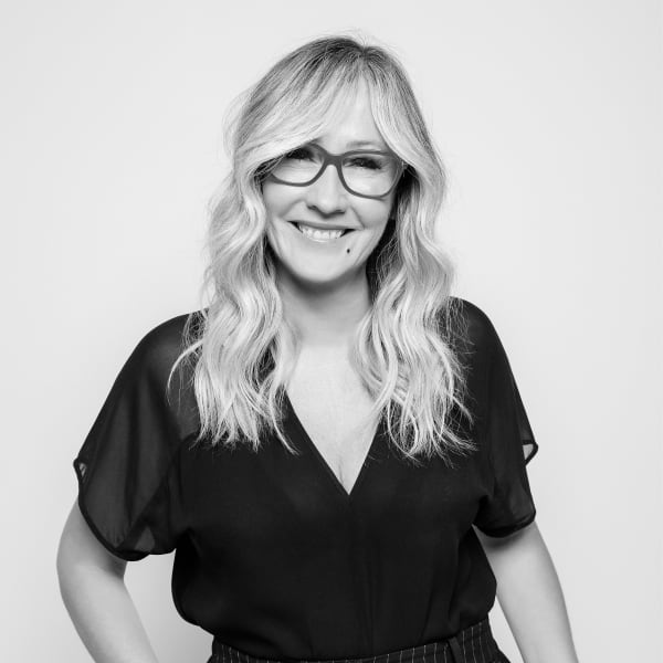 A smiling woman in glasses