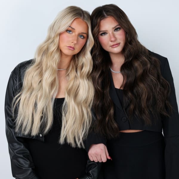 Arm in arm, two models with long extensions.