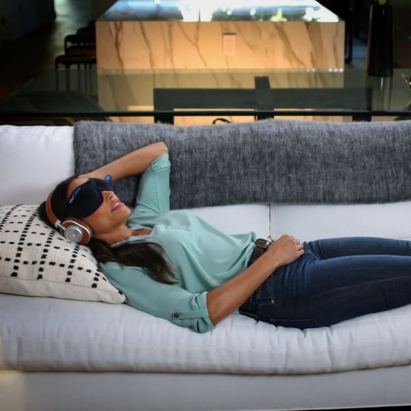 A woman sleeping on a couch.