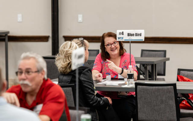 attendees share a lively discussion during a scheduled Work Truck Exchange appointment.