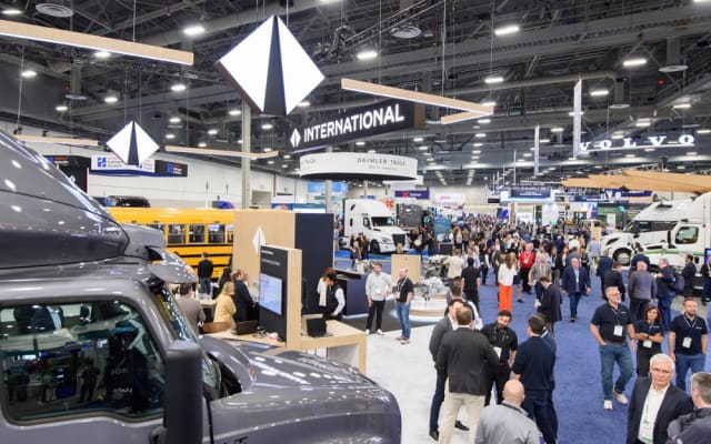 Attendees gather across the ACT Expo opening reception and exhibit hall featuring major commercial vehicle and electrification brands.