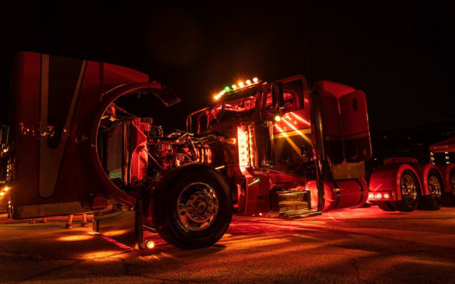 Peterbilt truck lit up at night.