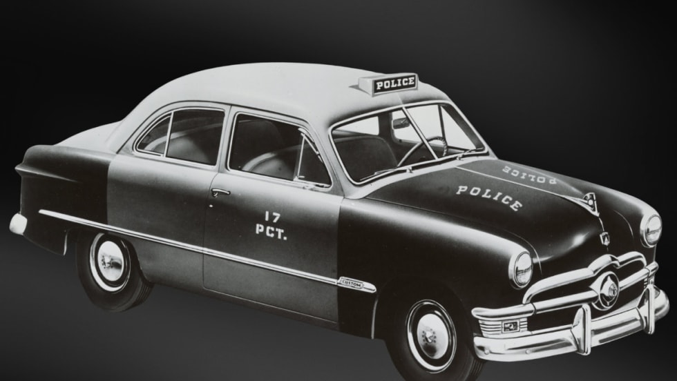 Vintage 1950s Ford police sedan with 17 PCT markings, black and white