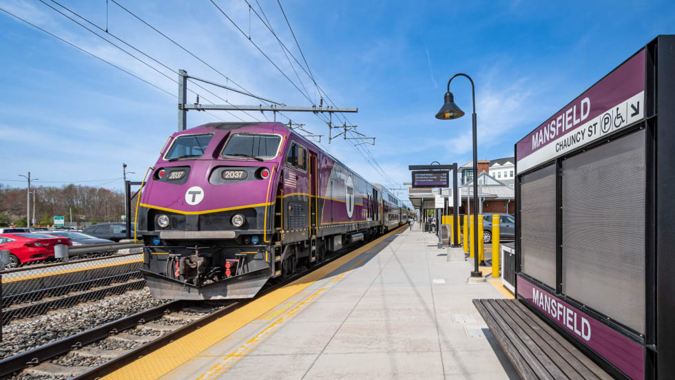 A purple MBTA train at a Mansfield Station platform.
