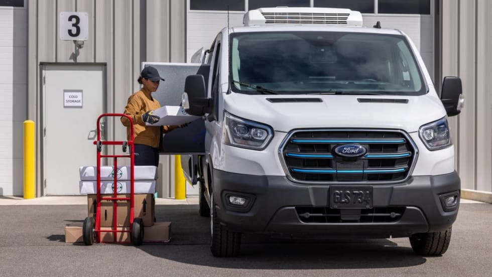 Photo of fleet driver and deliverer loading contents into a Ford E-Transit van.