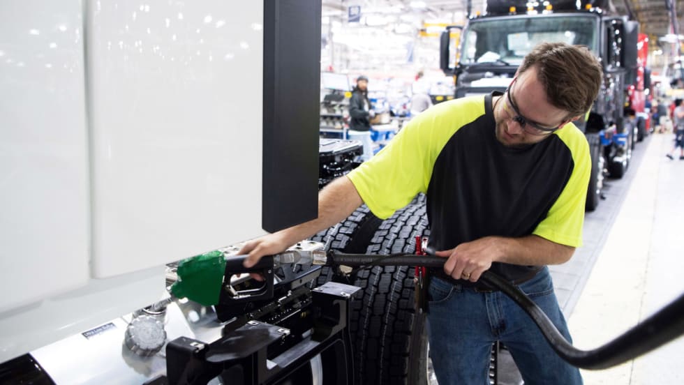 Technician fueling a truck with diesel 