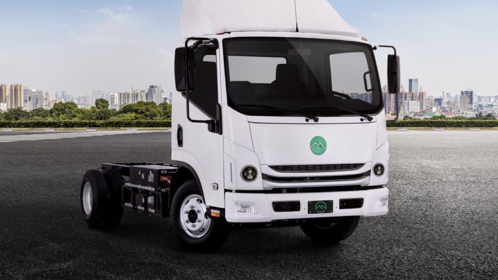 A Mullen Three battery-electric truck is shown from the front at a 3/5 angle to display the truck cab and the chassis.