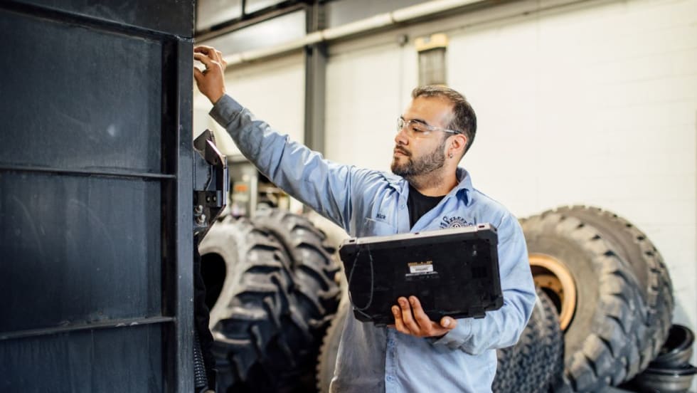 A technician by a work truck