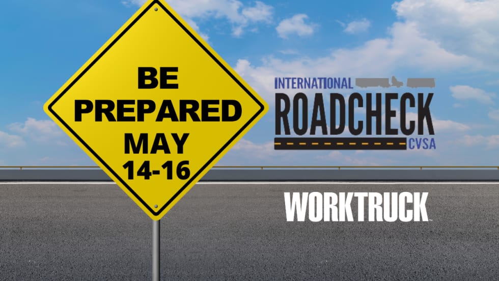 A yellow road sign that says "Be Prepared May 14-16" with International roadcheck logo for CVSA on a road background.