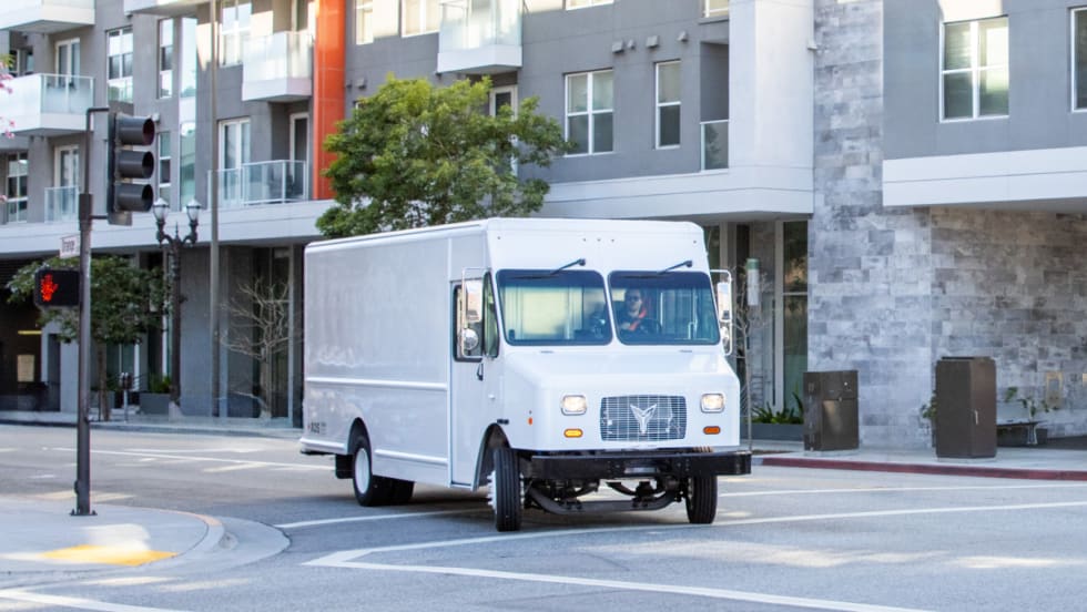 A white 2024 Xos Stepvan on a city street 