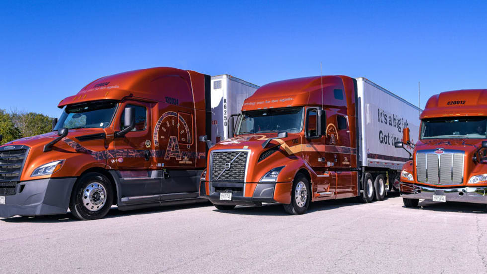 Three Arka Express tractor-trailers, Freightliner, Volvo, and Peterbilt