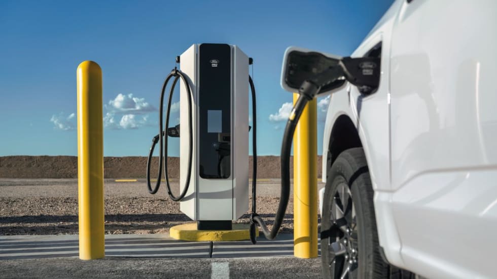 A white Ford electric truck charging