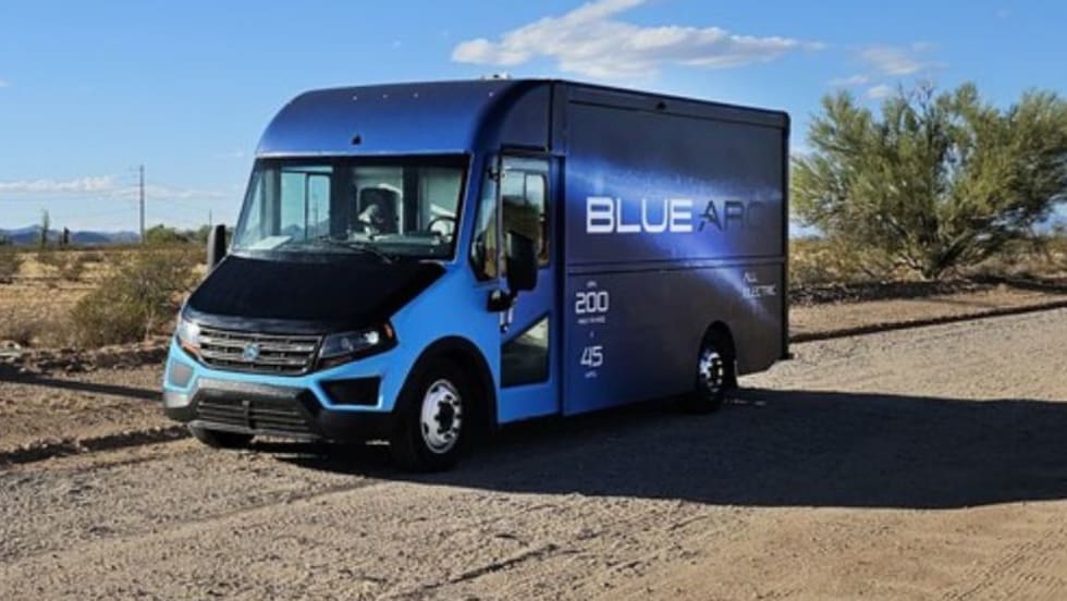 Blue step van facing left.