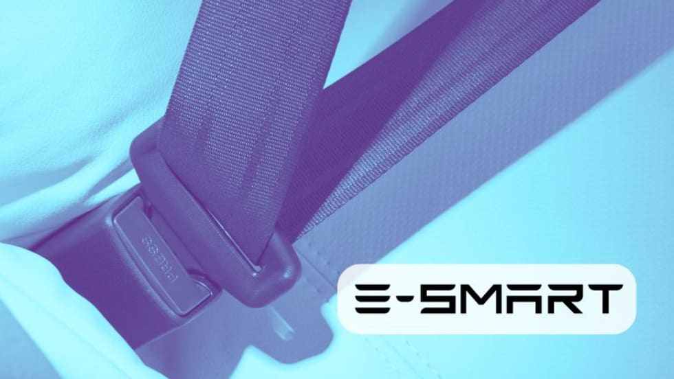 photo of a buckles seatbelt, with inset company logo for E-Smart.