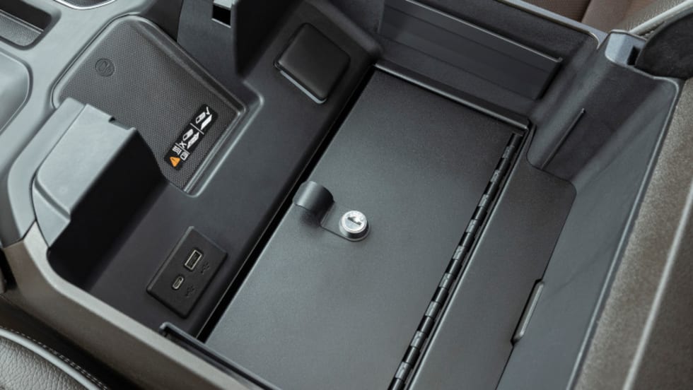Security safe installed in the center console of a pickup truck.