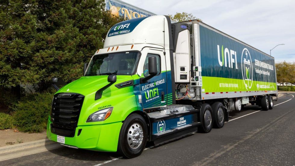 Green UNFI tractor-trailer with refrigeration unit (TRU)