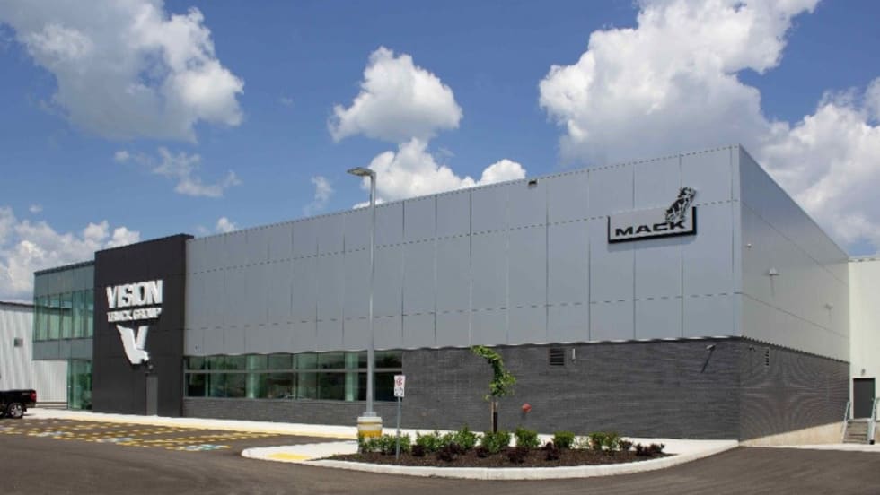Commercial building with logo for Mack Trucks and Vision Truck Center.