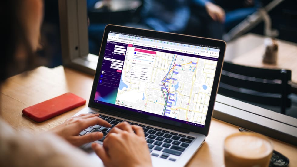 A woman at a laptop looking at Free2Move