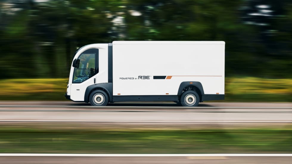 Side view of a white battery-electric truck.