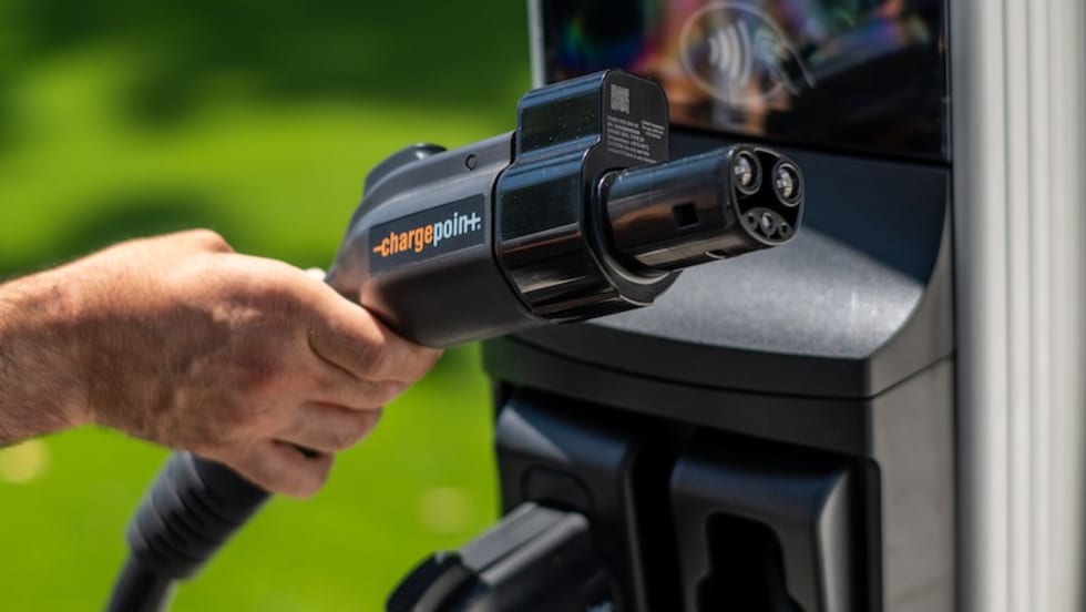Hand gripping EV charger