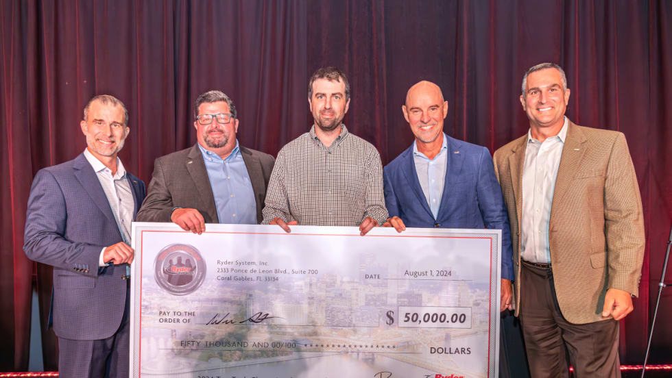 Group of five men holding a large check for $50,000.