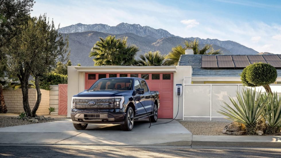 Ford F-150 Pickup Truck Charging outside of a home