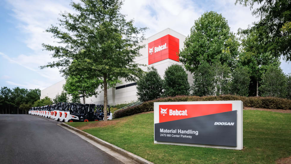 A clear view of the Bobcat factory sign positioned in front of the building, showcasing the brand's industrial presence.