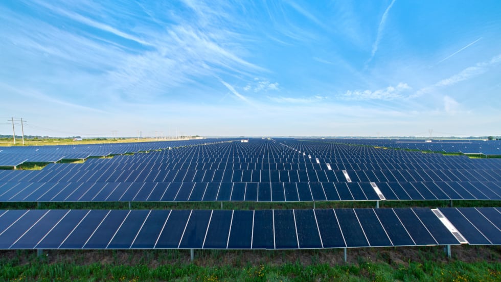 Photo of solar panels and blue sky.