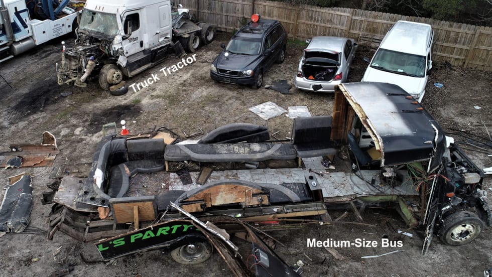 Tow yard photo of truck and bus post-crash