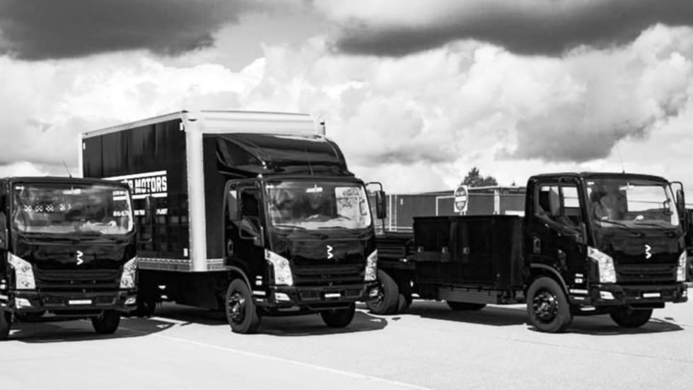 Black and white photo of three low cab forward Class 4 trucks.