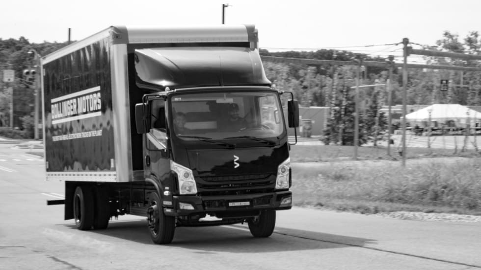 black box truck driving on road