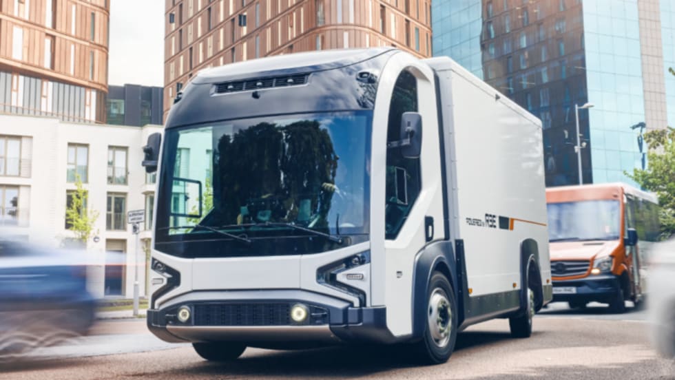Futuristic-looking box truck driving down a street.